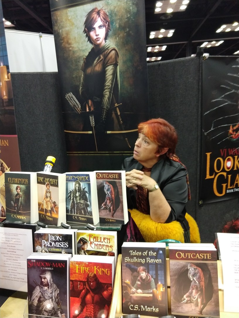 Author C.S. Marks discusses her books with prospective readers at Gen Con's Authors' Avenue